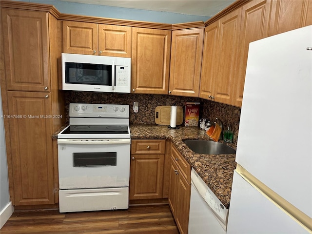 kitchen with sink, tasteful backsplash, dark hardwood / wood-style floors, and white appliances