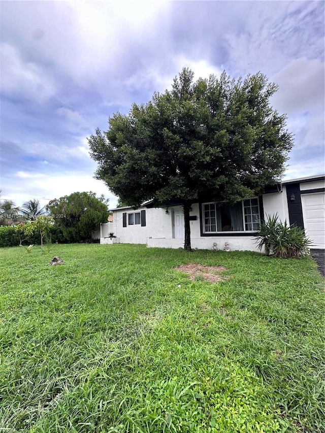 exterior space featuring a front yard and a garage