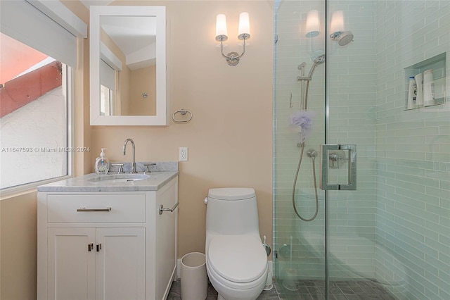 bathroom with a shower with door, toilet, and vanity