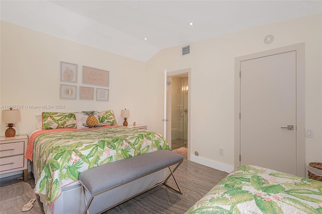 bedroom with vaulted ceiling and dark wood-type flooring