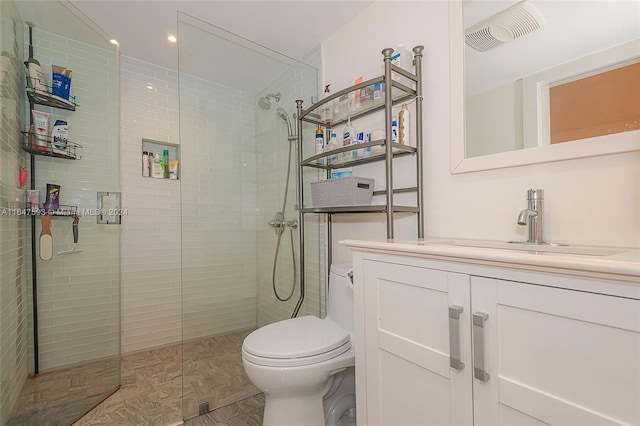 bathroom with an enclosed shower, vanity, and toilet