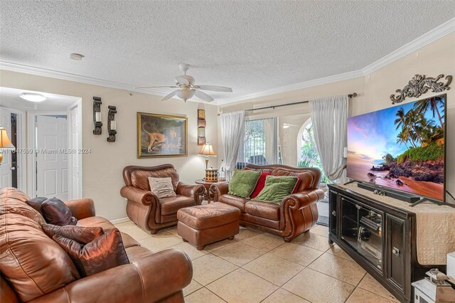 tiled living room featuring ceiling fan, crown molding, and a textured ceiling