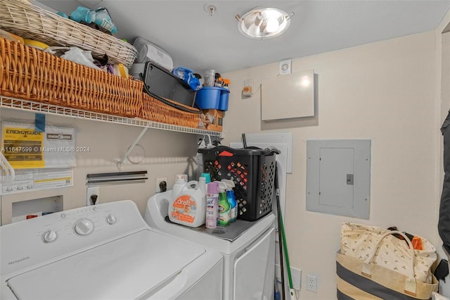 clothes washing area featuring washing machine and dryer, laundry area, and electric panel