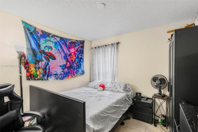 tiled bedroom featuring a textured ceiling