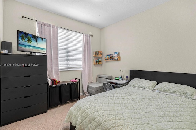 bedroom featuring light carpet