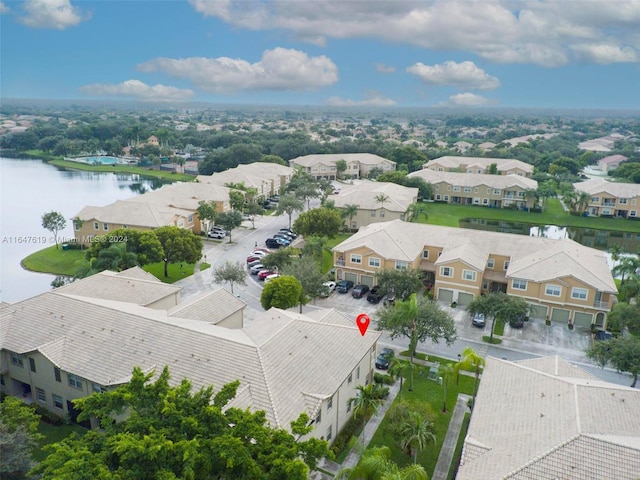 drone / aerial view featuring a water view and a residential view