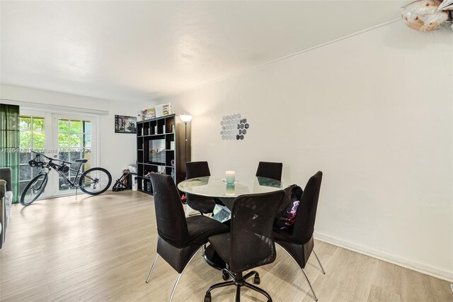 dining room featuring light hardwood / wood-style floors and french doors