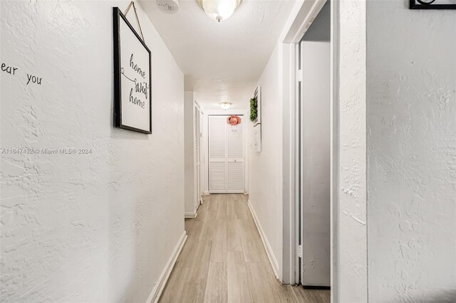 corridor with light wood-type flooring