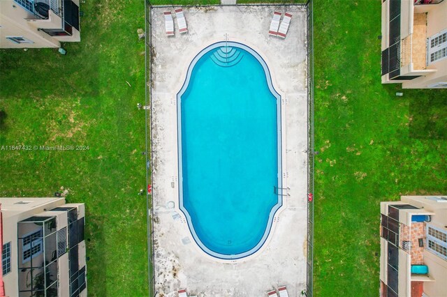 view of pool featuring a lawn