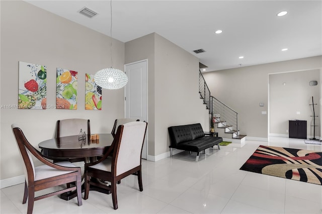 tiled dining room featuring a notable chandelier