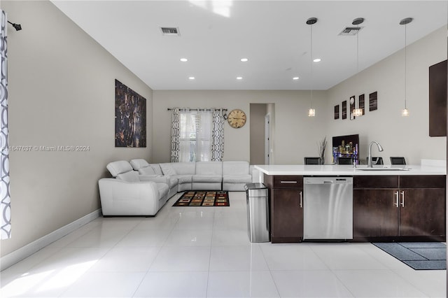 kitchen with sink, dark brown cabinetry, dishwasher, light tile patterned floors, and hanging light fixtures