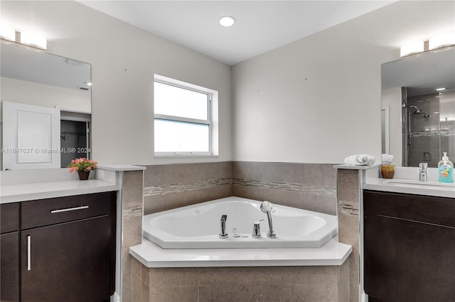 bathroom featuring independent shower and bath and vanity