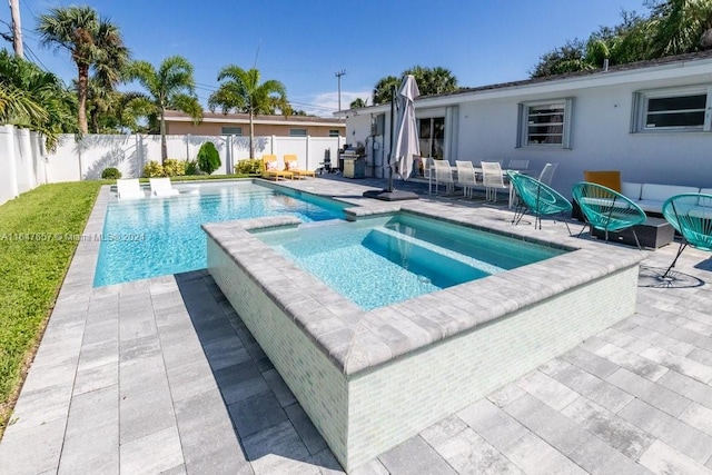 view of swimming pool with a patio area and an in ground hot tub