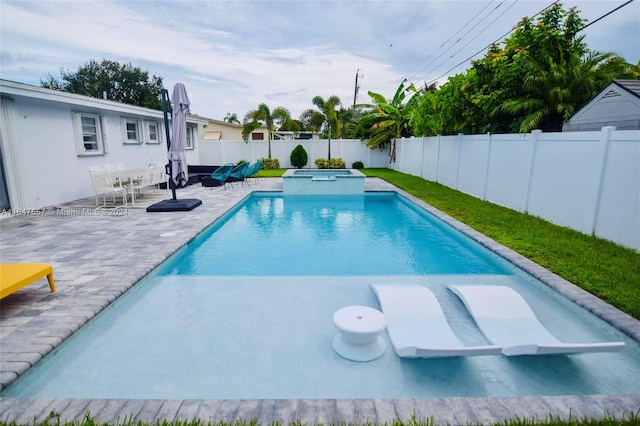 view of swimming pool featuring an in ground hot tub and a patio area