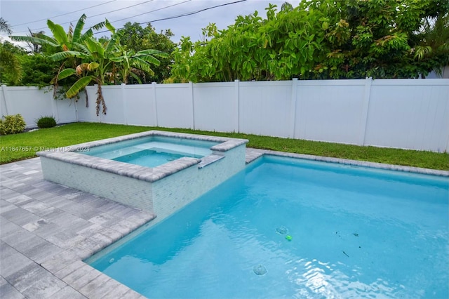 view of pool with a lawn and an in ground hot tub