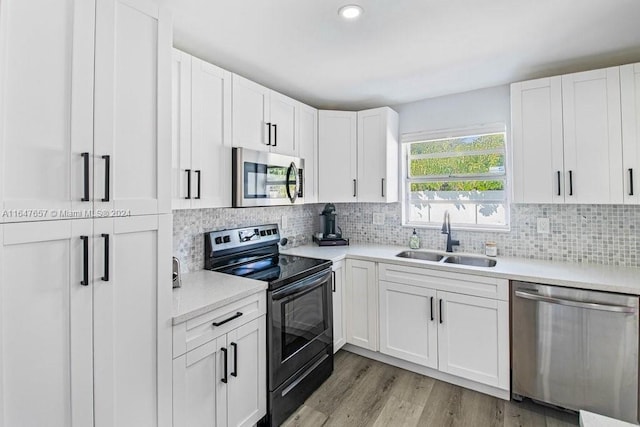 kitchen with white cabinets, sink, and appliances with stainless steel finishes