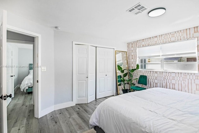 bedroom with a closet and light hardwood / wood-style floors