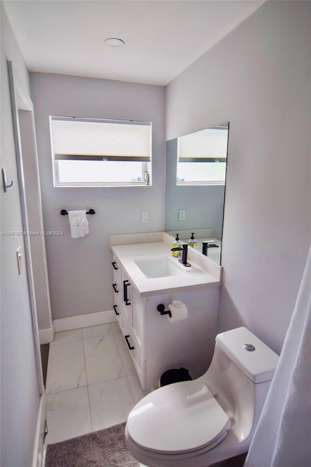 bathroom with vanity and toilet