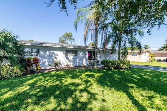 ranch-style home with a front lawn