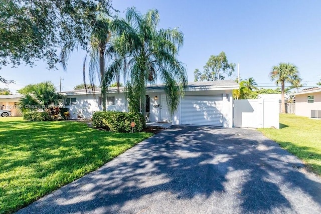 single story home featuring a front lawn and a garage