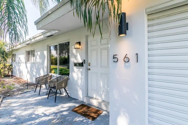 property entrance featuring a patio