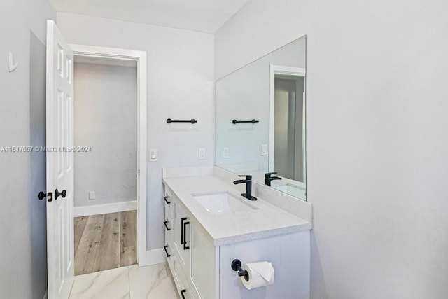 bathroom with hardwood / wood-style floors and vanity