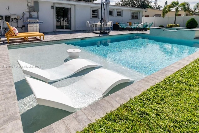 view of pool with a patio area and an in ground hot tub