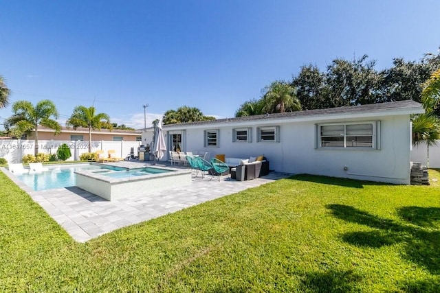 back of house with outdoor lounge area, a swimming pool with hot tub, a patio area, and a yard