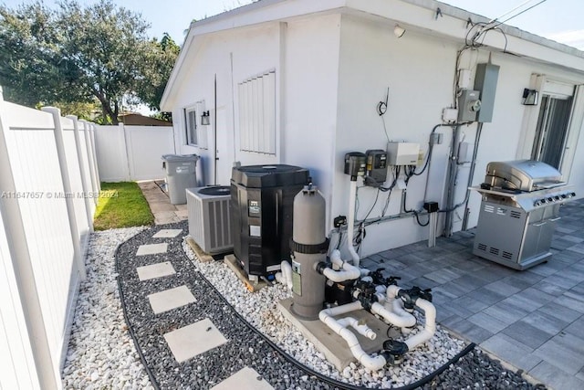 view of home's exterior with central AC and a patio area