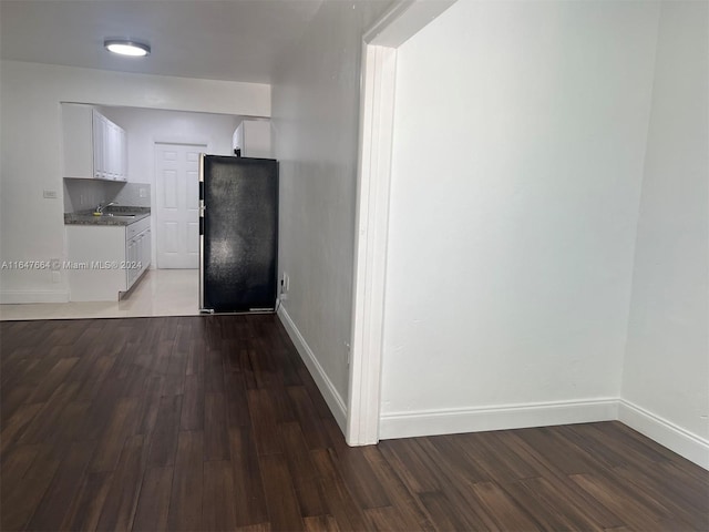 hall with sink and dark wood-type flooring