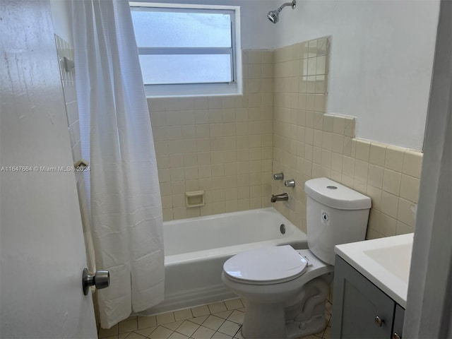 full bathroom with tile walls, vanity, tile patterned flooring, shower / bath combo, and toilet