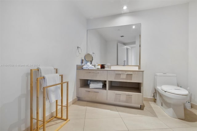 bathroom featuring tile patterned flooring, vanity, and toilet