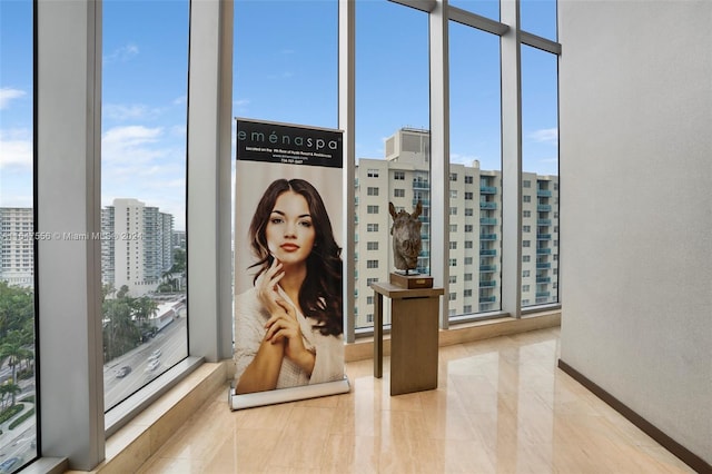 interior space featuring plenty of natural light and a wall of windows