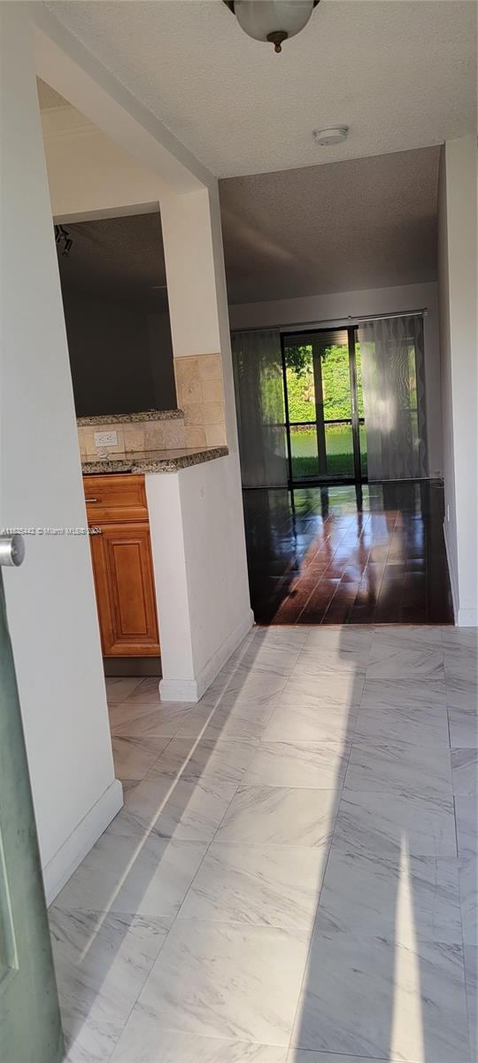 hallway with marble finish floor