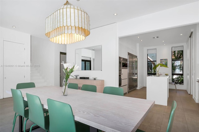 dining space with recessed lighting and stairs