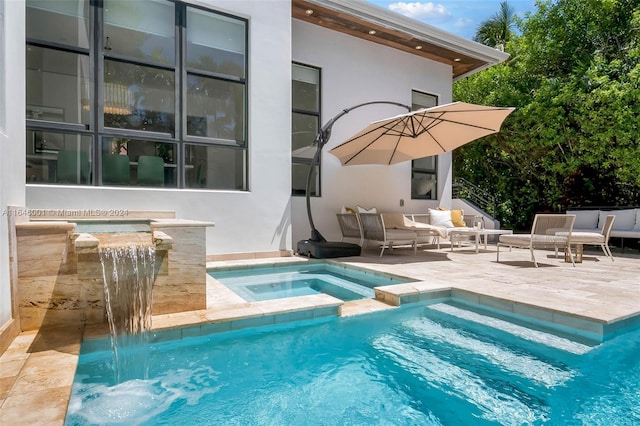 view of swimming pool featuring a patio area and an in ground hot tub