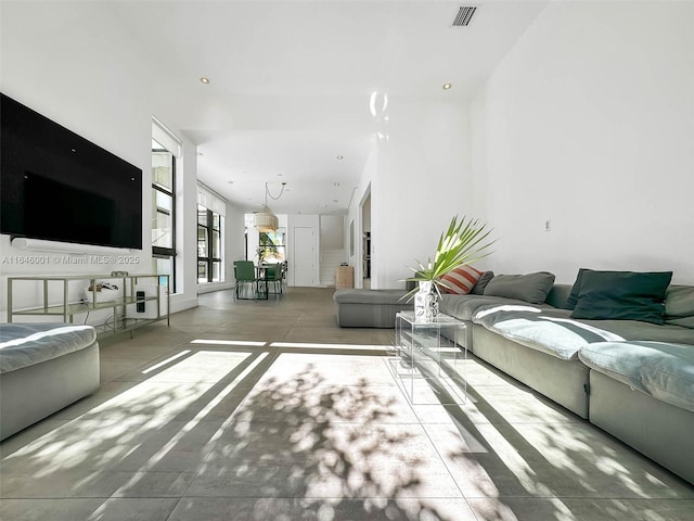 unfurnished living room with recessed lighting and visible vents