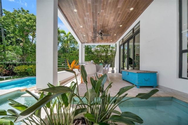 view of patio featuring ceiling fan