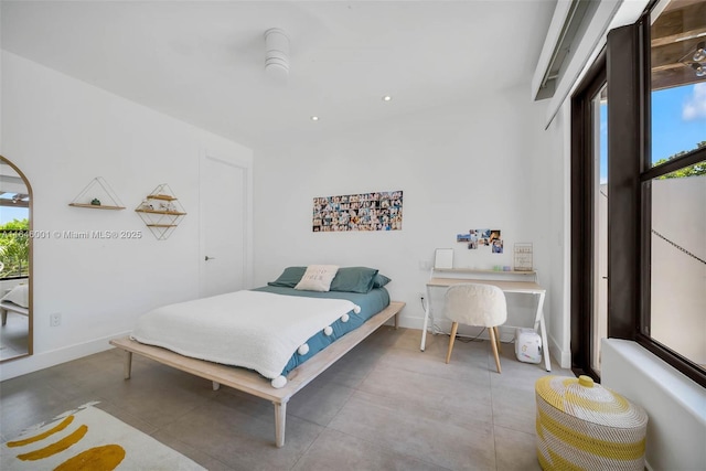 tiled bedroom with multiple windows and baseboards