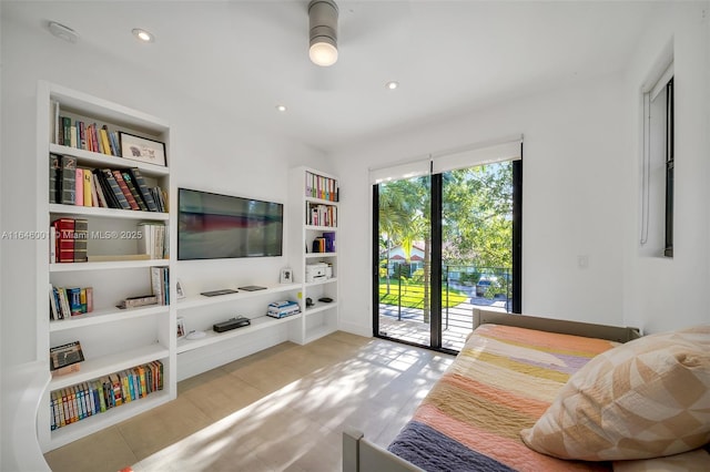 living area with built in features and recessed lighting