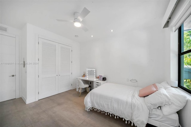 tiled bedroom with multiple windows, a closet, and ceiling fan