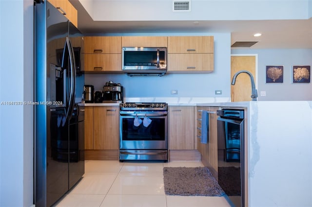 kitchen with wine cooler, appliances with stainless steel finishes, sink, and light tile patterned floors