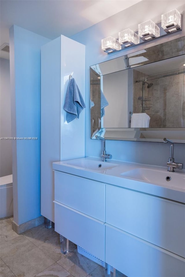 bathroom with vanity, tile patterned floors, and tiled shower