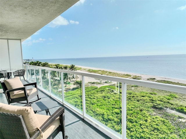 balcony with a view of the beach and a water view