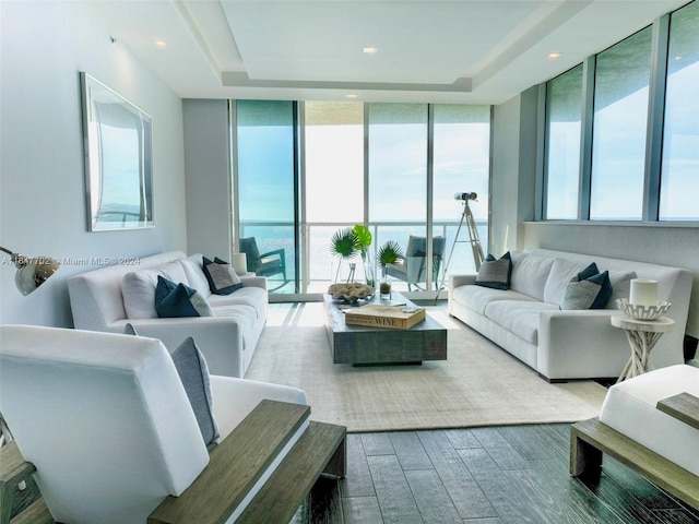 living room featuring a wall of windows and hardwood / wood-style flooring