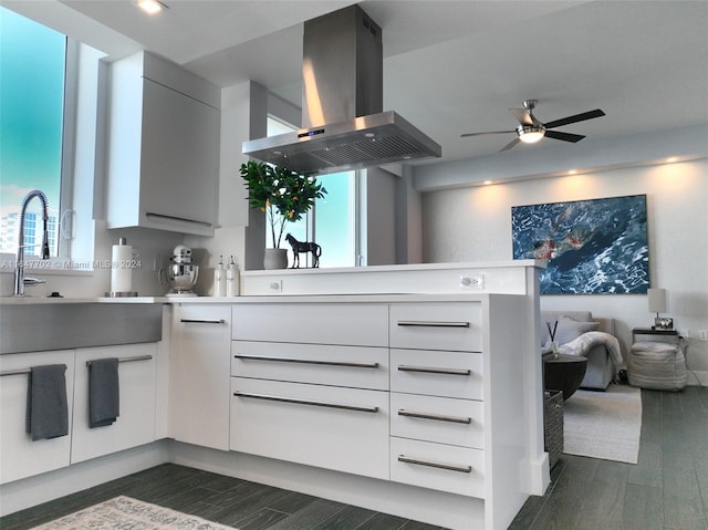 kitchen featuring white cabinetry, island exhaust hood, dark hardwood / wood-style flooring, and ceiling fan