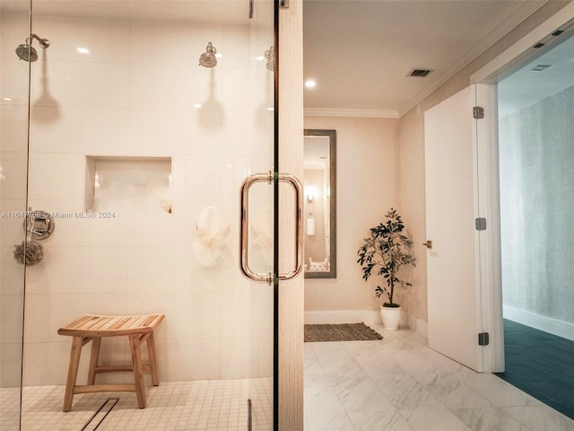 bathroom with ornamental molding and a shower with shower door