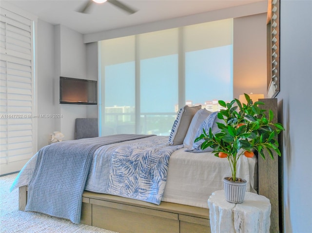 bedroom featuring ceiling fan and carpet