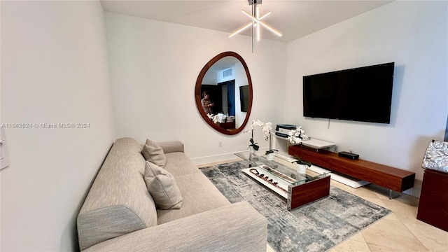 living room with light tile patterned floors and a chandelier