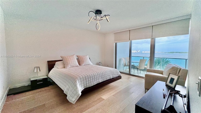 1331 Brickell Bay Dr Unit 1109, Miami, FL 33131 - bedroom with wood-type flooring and access to exterior